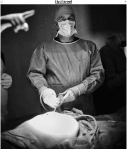 Surgeon performing an operation in a medical facility, demonstrating the urgent need for medical support.
