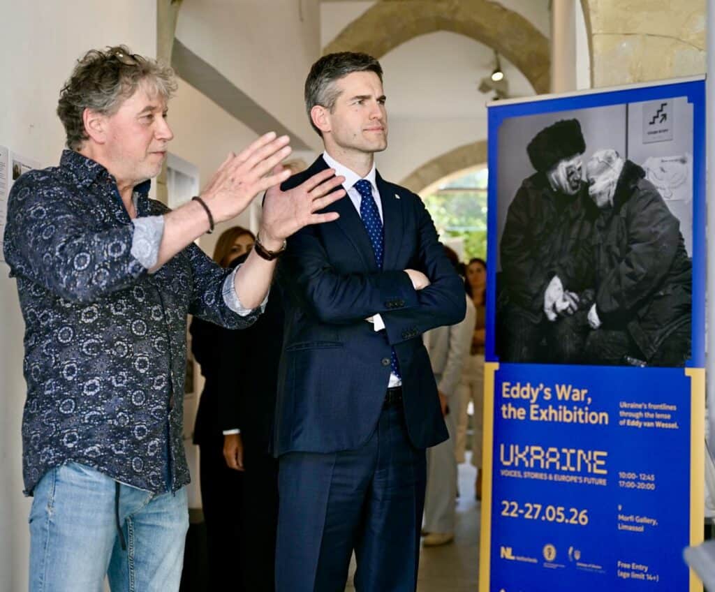 Eddy van Wessel with Tom Berendsen, Dutch Minister of Foreign Affairs, watching one of his photographs during the opening of the exhibition at Limassol, Cyprus.